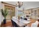 Spacious dining room featuring hardwood floors, large windows, and elegant chandelier at 4853 Stonehall Pl, Atlanta, GA 30339