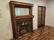 Close-up of decorative fireplace with wood mantle and glass-paneled doors at 4853 Stonehall Pl, Atlanta, GA 30339