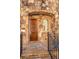 Close-up of a stunning stone entryway featuring a beautiful wooden door and decorative iron railing at 4853 Stonehall Pl, Atlanta, GA 30339