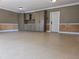 Spacious garage featuring built-in storage cabinets and clean, epoxy-coated flooring at 4853 Stonehall Pl, Atlanta, GA 30339