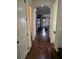 Inviting hallway featuring hardwood floors and arched doorway that leads to other rooms at 4853 Stonehall Pl, Atlanta, GA 30339