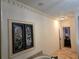 Hallway leading to a bedroom with decorative trim and a stained glass window feature at 4853 Stonehall Pl, Atlanta, GA 30339