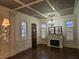 Elegant living room features dark wood floors, a fireplace, and detailed trim with coffered ceiling at 4853 Stonehall Pl, Atlanta, GA 30339