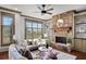 Inviting living room featuring a stone fireplace and large windows with natural light at 4853 Stonehall Pl, Atlanta, GA 30339