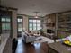 Spacious living room with stone fireplace, built-in shelving, and lots of natural light at 4853 Stonehall Pl, Atlanta, GA 30339