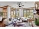 Bright living room boasts a stone fireplace and large windows providing ample natural light at 4853 Stonehall Pl, Atlanta, GA 30339