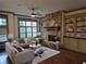 Cozy living room featuring a stone fireplace, built-in cabinets, and hardwood floors at 4853 Stonehall Pl, Atlanta, GA 30339