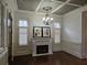 Beautiful living room with dark wood floors, a fireplace, and detailed trim with coffered ceiling at 4853 Stonehall Pl, Atlanta, GA 30339