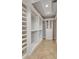 Bright walk-in closet featuring custom shelving, tile floors, and a dresser at 4853 Stonehall Pl, Atlanta, GA 30339