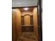 Wooden wine cellar with built in storage, custom shelves and a light fixture at 4853 Stonehall Pl, Atlanta, GA 30339