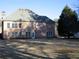 Expansive brick home featuring a large backyard, windows, and a door leading to outdoor space at 354 Mansfield Way, Stockbridge, GA 30281