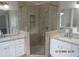 Elegant bathroom with a glass enclosed shower, granite countertops, and white cabinets at 354 Mansfield Way, Stockbridge, GA 30281