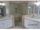 Modern bathroom with double vanity, granite countertops, and a glass-enclosed shower at 354 Mansfield Way, Stockbridge, GA 30281
