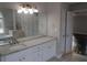 Bathroom featuring double sinks with granite counters, a large mirror, and a tub at 354 Mansfield Way, Stockbridge, GA 30281
