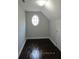 Cozy bedroom featuring hardwood floors and a charming oval window, enhancing natural light at 354 Mansfield Way, Stockbridge, GA 30281