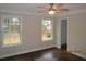 Bedroom featuring neutral paint, crown molding, hardwood flooring, and natural light from the double windows at 354 Mansfield Way, Stockbridge, GA 30281