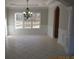Elegant dining room features neutral colors, wainscoting, and a stylish chandelier over tile flooring at 354 Mansfield Way, Stockbridge, GA 30281