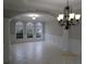 Elegant dining room with decorative chandelier, beautiful trim work and large arched windows at 354 Mansfield Way, Stockbridge, GA 30281