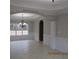 Elegant dining room with a decorative chandelier, beautiful trim work, and a large window at 354 Mansfield Way, Stockbridge, GA 30281