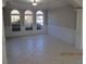 Charming dining room with paneled wainscoting, three arched windows, and neutral tile flooring at 354 Mansfield Way, Stockbridge, GA 30281