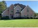Beautiful brick home with meticulously maintained lawn and mature trees offers classic curb appeal at 354 Mansfield Way, Stockbridge, GA 30281
