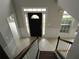 Entryway featuring a black front door with sidelights and transom window, tiled floor and wainscoting at 354 Mansfield Way, Stockbridge, GA 30281