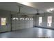 The garage has a multi-panel garage door, two windows, a service door, and a gray painted floor at 354 Mansfield Way, Stockbridge, GA 30281