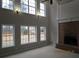 Bright room with a brick fireplace, multiple windows, and high ceilings provide natural light at 354 Mansfield Way, Stockbridge, GA 30281