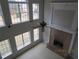 Spacious living room with fireplace, large windows, and ceiling fan offering plenty of natural light at 354 Mansfield Way, Stockbridge, GA 30281