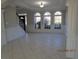 Spacious room with tile flooring, wainscoting, and three arched windows that let in lots of natural light at 354 Mansfield Way, Stockbridge, GA 30281
