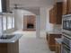 Open-concept kitchen and living area featuring a brick fireplace and abundant natural light at 354 Mansfield Way, Stockbridge, GA 30281