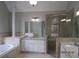 The main bathroom boasts double vanity, shower, soaking tub, and granite countertop at 354 Mansfield Way, Stockbridge, GA 30281