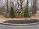 Community sign for Ivory Estates framed by two trees, shrubs, and mulch at 354 Mansfield Way, Stockbridge, GA 30281