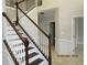 Staircase featuring wood treads and railings with white risers and spindles at 354 Mansfield Way, Stockbridge, GA 30281