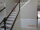 Elegant staircase with dark wood treads, white risers, and matching wood handrails at 354 Mansfield Way, Stockbridge, GA 30281