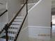 Staircase featuring wood treads and railings with white risers and spindles at 354 Mansfield Way, Stockbridge, GA 30281