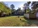 Spacious backyard with detached storage shed and tree-filled surroundings at 5094 Mable Lake Sw Dr, Mableton, GA 30126