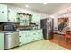 Light green kitchen with stainless steel appliances and wood flooring at 5094 Mable Lake Sw Dr, Mableton, GA 30126