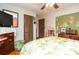 Main bedroom with hardwood floors, ceiling fan and tropical wall art at 5094 Mable Lake Sw Dr, Mableton, GA 30126