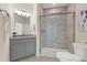 Modern bathroom featuring a glass-enclosed shower, granite vanity, and neutral-toned tile at 5225 Maggie Mae Ln, Cumming, GA 30028