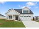 Charming two-story home featuring a covered porch and a two-car garage in a suburban setting at 5225 Maggie Mae Ln, Cumming, GA 30028