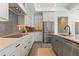 Well-lit kitchen featuring granite countertops, stainless steel appliances, and modern cabinetry at 5225 Maggie Mae Ln, Cumming, GA 30028