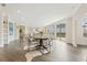 Open-concept living and dining area with hardwood floors, modern lighting, and ample natural light at 5225 Maggie Mae Ln, Cumming, GA 30028