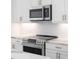 Stainless steel appliances with modern hardware, tile backsplash and marble countertops at 371 Grant Se Cir # 1814, Atlanta, GA 30315