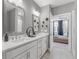 Bright bathroom featuring double sink, white vanity, patterned floor tile, and modern finishes at 371 Grant Se Cir # 1814, Atlanta, GA 30315