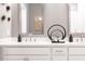 Close up on vanity in bathroom highlighting the quartz countertop and double sinks with decor at 371 Grant Se Cir # 1814, Atlanta, GA 30315