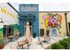Exterior view of outdoor seating area featuring multiple restaurants and mural art at 371 Grant Se Cir # 1814, Atlanta, GA 30315