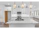 Close up of a spacious kitchen island with marble countertop and decorative lighting fixtures at 371 Grant Se Cir # 1814, Atlanta, GA 30315