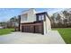 Modern home exterior with dark brown garage doors at 1660 Union Grove Church Rd, Auburn, GA 30011