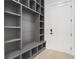 Stylish mudroom with gray custom shelving and a white door at 1660 Union Grove Church Rd, Auburn, GA 30011